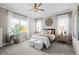 Bright bedroom with a ceiling fan, decorative lamps, and an exterior view at 5707 Cadara Way, Parker, CO 80134