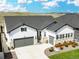 Beautiful exterior elevation of a bright, modern house featuring a two-car garage and manicured front yard at 5707 Cadara Way, Parker, CO 80134