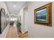 Inviting hallway with stylish decor and wood flooring leading to a bright living area at 5707 Cadara Way, Parker, CO 80134