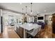 Open-concept kitchen and living room with hardwood floors, modern appliances, and comfortable seating at 5707 Cadara Way, Parker, CO 80134