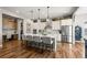 Open-concept kitchen featuring stainless appliances, quartz countertop and a large center island with barstool seating at 5707 Cadara Way, Parker, CO 80134