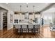 Bright, open kitchen features a large center island with seating and pendant lighting above at 5707 Cadara Way, Parker, CO 80134