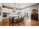 Bright, open-concept kitchen with an oversized center island, modern appliances, and hardwood floors at 5707 Cadara Way, Parker, CO 80134
