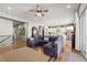 Open-concept living room featuring hardwood floors, comfortable seating, and seamless flow into kitchen at 5707 Cadara Way, Parker, CO 80134