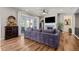 Bright living room with fireplace, entertainment center, and sliding doors to the backyard patio at 5707 Cadara Way, Parker, CO 80134