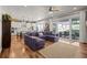 Spacious living room and kitchen, with a large sectional couch, hardwood floors, and sliding glass doors at 5707 Cadara Way, Parker, CO 80134
