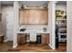Dedicated office space featuring custom cabinetry, a built-in desk, and a convenient pantry at 5707 Cadara Way, Parker, CO 80134