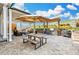 Inviting outdoor space includes a dining area, outdoor grill, and comfortable seating by a stone fire pit at 5707 Cadara Way, Parker, CO 80134
