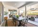 Expansive covered patio featuring an outdoor dining area, seating, and hillside views at 5707 Cadara Way, Parker, CO 80134