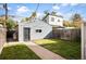 Large backyard with detached garage and brick pathway leading to the house at 1152 Clayton St, Denver, CO 80206