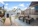 Deck with table and benches, overlooking a grassy backyard with a detached garage at 1152 Clayton St, Denver, CO 80206