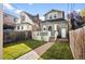 Landscaped backyard with a deck, detached garage, and brick pathway at 1152 Clayton St, Denver, CO 80206