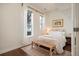 Charming bedroom with striped bedding and wood floors at 1152 Clayton St, Denver, CO 80206