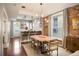 Open concept dining area with a live edge table and exposed brick wall at 1152 Clayton St, Denver, CO 80206