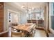 Bright dining room with a large live-edge table and seating for six, open to the kitchen at 1152 Clayton St, Denver, CO 80206