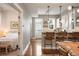 Open concept kitchen with island seating, white cabinets, and stainless steel appliances at 1152 Clayton St, Denver, CO 80206