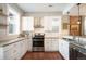 Modern kitchen with white cabinets, stainless steel appliances, and an eat-in island at 1152 Clayton St, Denver, CO 80206