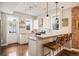 Modern kitchen featuring white shaker cabinets, stainless steel appliances, and breakfast bar at 1152 Clayton St, Denver, CO 80206