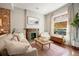 Living room with a fireplace, large windows and hardwood floors at 1152 Clayton St, Denver, CO 80206