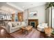 Light-filled living room with exposed brick wall and hardwood floors at 1152 Clayton St, Denver, CO 80206