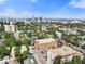 Aerial view of the neighborhood buildings with vibrant trees and the city skyline on a bright day at 1350 Josephine St # 502, Denver, CO 80206