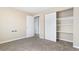 This carpeted bedroom features a closet with sliding doors and a glimpse into another room at 1350 Josephine St # 502, Denver, CO 80206