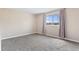 Bright bedroom with a large window providing natural light, neutral paint and carpeted floors at 1350 Josephine St # 502, Denver, CO 80206