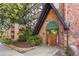Exterior of building entrance with brick facade and mature landscaping at Dublin Terrace 1350 at 1350 Josephine St # 502, Denver, CO 80206