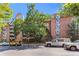 Multi-story brick building featuring unique architectural details and well-maintained landscaping at 1350 Josephine St # 502, Denver, CO 80206