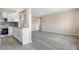 Open-concept living area showcases wood-look flooring adjacent to a stylish kitchen with modern finishes at 1350 Josephine St # 502, Denver, CO 80206