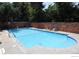 Inviting outdoor swimming pool with lounge chairs and a brick fence for privacy at 1350 Josephine St # 502, Denver, CO 80206