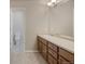 Double vanity bathroom with wood cabinets and a large mirror at 16911 Buffalo Valley Path, Monument, CO 80132