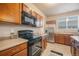 Bright kitchen with stainless steel appliances and wood cabinets at 16911 Buffalo Valley Path, Monument, CO 80132