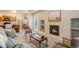 Living room with fireplace, kitchen view, and comfortable seating at 16911 Buffalo Valley Path, Monument, CO 80132