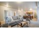 Living room with sofa, coffee table, and view into kitchen area at 16911 Buffalo Valley Path, Monument, CO 80132