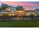 Beautiful backyard featuring a raised deck, lush lawn, and retaining wall, perfect for outdoor entertaining at 18601 E Louisiana Ave, Aurora, CO 80017