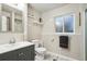 Bright bathroom featuring a gray vanity, modern fixtures, and a marble floor at 18601 E Louisiana Ave, Aurora, CO 80017