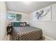 Bedroom in basement with window, artwork, and bedside table with lamp at 18601 E Louisiana Ave, Aurora, CO 80017