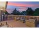 Outdoor wooden deck features patio furniture and a calming view of the neighborhood at 18601 E Louisiana Ave, Aurora, CO 80017
