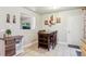 Dining area featuring a tile floor, a dark wooden table, shelving and wall art at 18601 E Louisiana Ave, Aurora, CO 80017