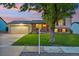 Charming home boasts a well-manicured lawn, two-car garage, and inviting exterior at 18601 E Louisiana Ave, Aurora, CO 80017