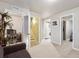 Hallway leading to a bedroom, laundry, and staircase with a gray carpet at 18601 E Louisiana Ave, Aurora, CO 80017