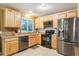 The kitchen is equipped with stainless steel appliances, and wooden cabinets at 18601 E Louisiana Ave, Aurora, CO 80017