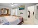 Main bedroom featuring a ceiling fan, dresser and view of the walk in closet at 18601 E Louisiana Ave, Aurora, CO 80017