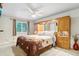 Main bedroom features a large bed, ceiling fan, and a built-in wardrobe with ample storage at 18601 E Louisiana Ave, Aurora, CO 80017