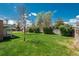 Large, well-maintained backyard with mature trees and privacy fence at 1077 Salem St, Aurora, CO 80011