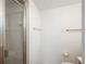 Bathroom featuring tiled walls, shower with glass doors, and gold fixtures at 1077 Salem St, Aurora, CO 80011