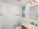 Bright bathroom featuring white walls, a wood vanity, and a window providing natural light at 1077 Salem St, Aurora, CO 80011