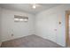 Carpeted bedroom featuring a window and a door at 1077 Salem St, Aurora, CO 80011
