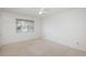 Bright bedroom features a ceiling fan, carpeted floors, and a window offering neighborhood views at 1077 Salem St, Aurora, CO 80011